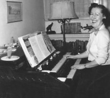At home in Long Beach in 1950, Nadine plays her organ (topped with Jack Gardner’s model airplanes, including a P-38).
