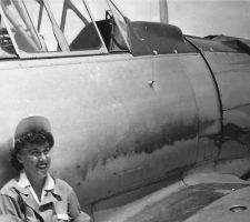 Arriving at Avenger Field in Sweetwater, Texas, in 1943, Nadine takes a break beside a BT-13 Vultee Variant training aircraft in summer 1943.